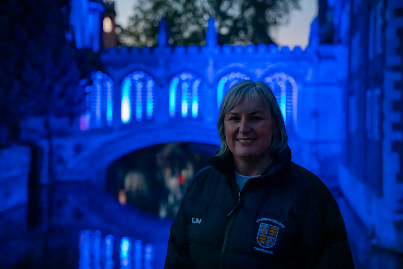 Emma Manuel, College Nurse, in front of the Bridge of Sighs, lit up in blue for the  NHS